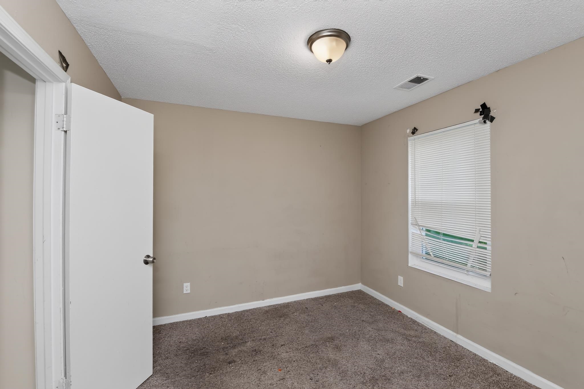 3953 McCain Road Memphis, TN 38109 - Photo 10 of 15 Neutral-toned walls complement the textured carpeting
