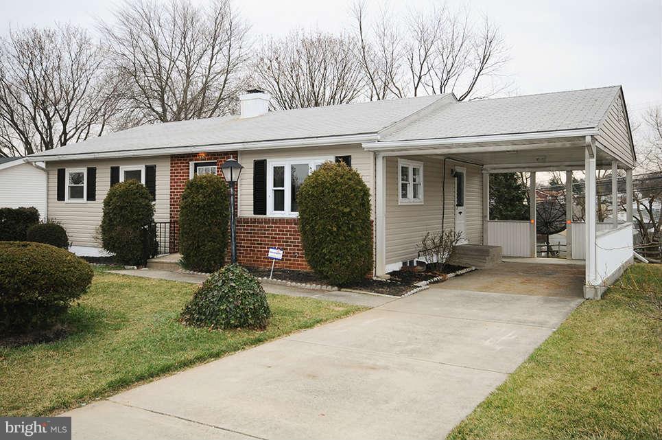 725 Crosby Road Baltimore, MD 21228 - Photo 4 of 24 a front view of a house with a yard and potted plants