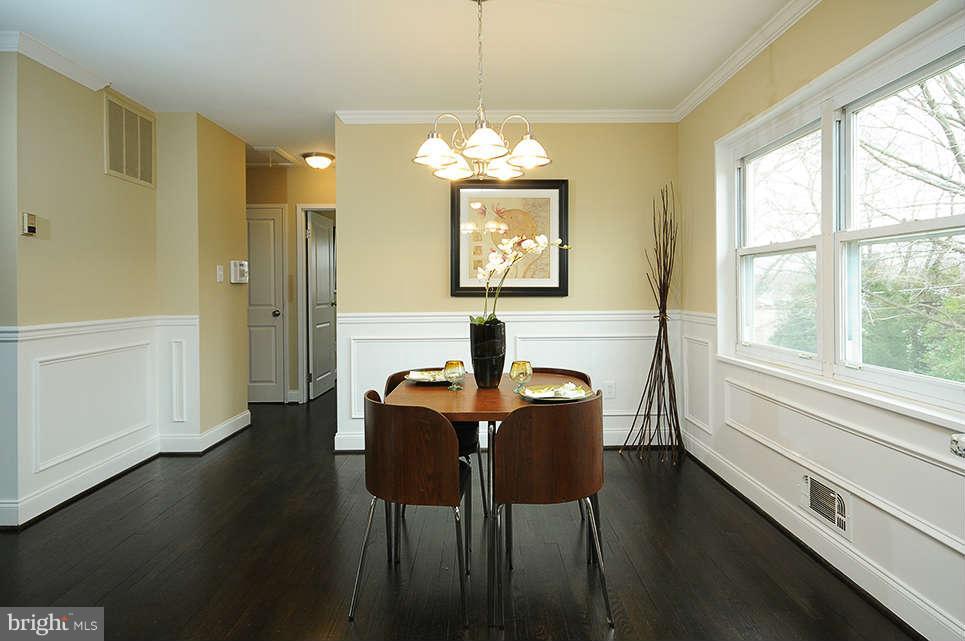 725 Crosby Road Baltimore, MD 21228 - Photo 8 of 24 a dining room with chandelier and wooden floor