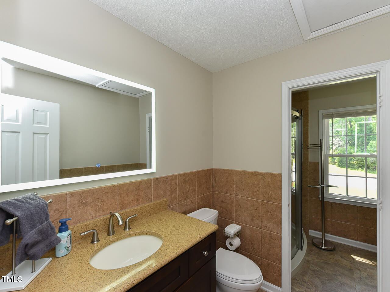 1215 Brookgreen Drive Cary, NC 27511 - Photo 13 of 40 a bathroom with a sink vanity mirror and toilet