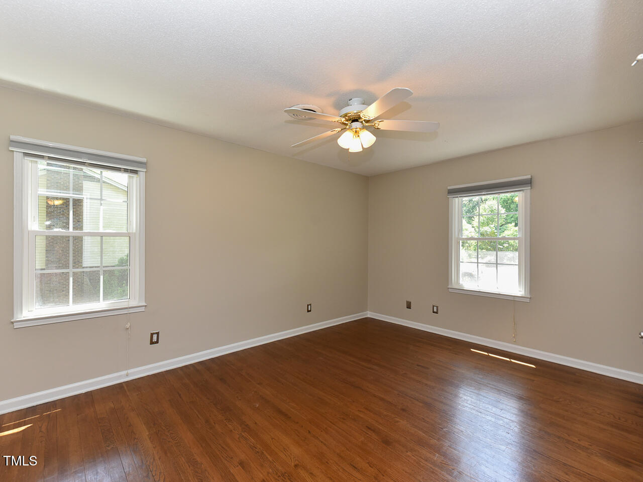 1215 Brookgreen Drive Cary, NC 27511 - Photo 14 of 40 a view of empty room with wooden floor and fan