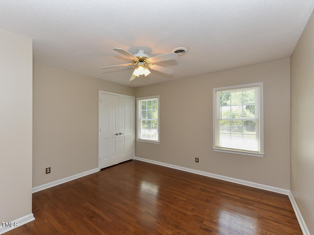 1215 Brookgreen Drive Cary, NC 27511 - Photo 15 of 40 a view of an empty room with wooden floor and a window