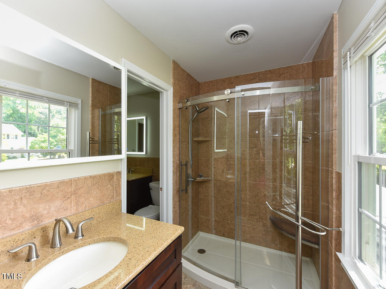 1215 Brookgreen Drive Cary, NC 27511 - Photo 17 of 40 a bathroom with a granite countertop sink mirror and shower