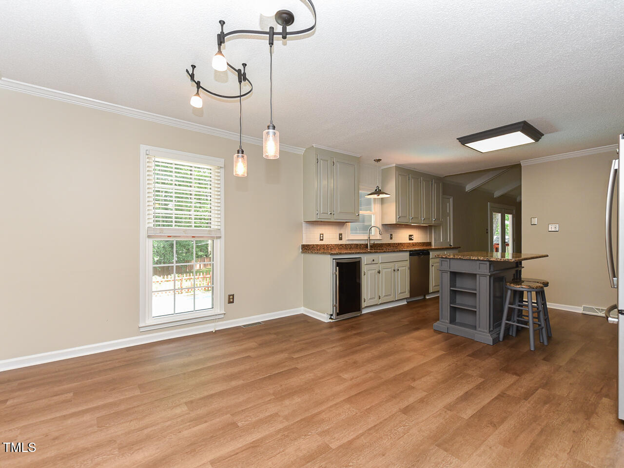 1215 Brookgreen Drive Cary, NC 27511 - Photo 18 of 40 a large kitchen with cabinets wooden floor and stainless steel appliances