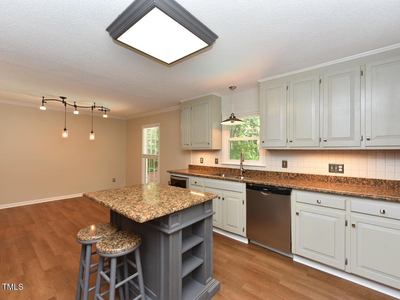 1215 Brookgreen Drive Cary, NC 27511 - Photo 21 of 40 a kitchen with granite countertop sink stove and dining table