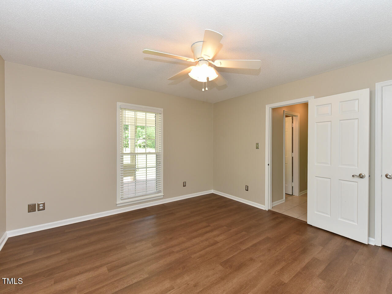 1215 Brookgreen Drive Cary, NC 27511 - Photo 24 of 40 a view of an empty room with wooden floor and a window