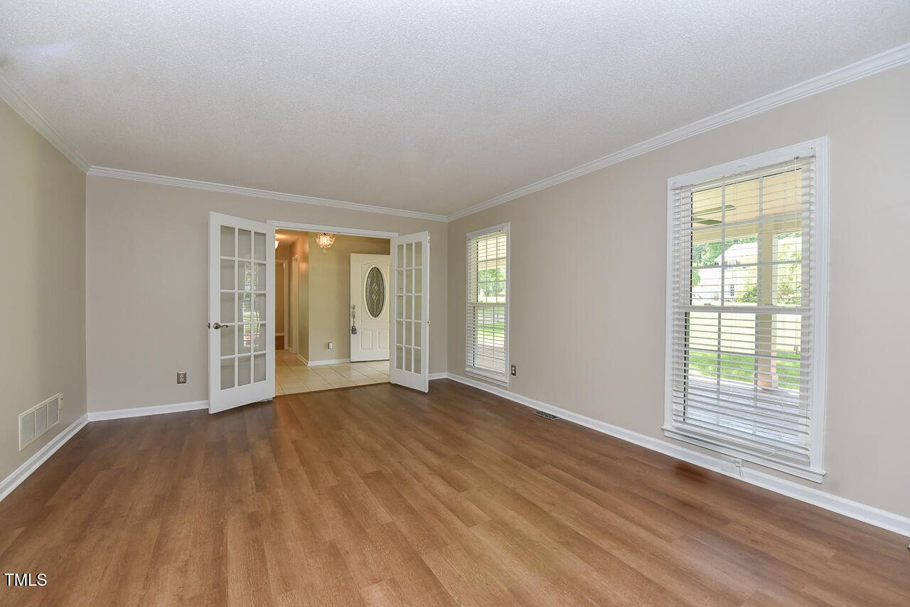 1215 Brookgreen Drive Cary, NC 27511 - Photo 26 of 40 a view of an empty room with wooden floor and a window