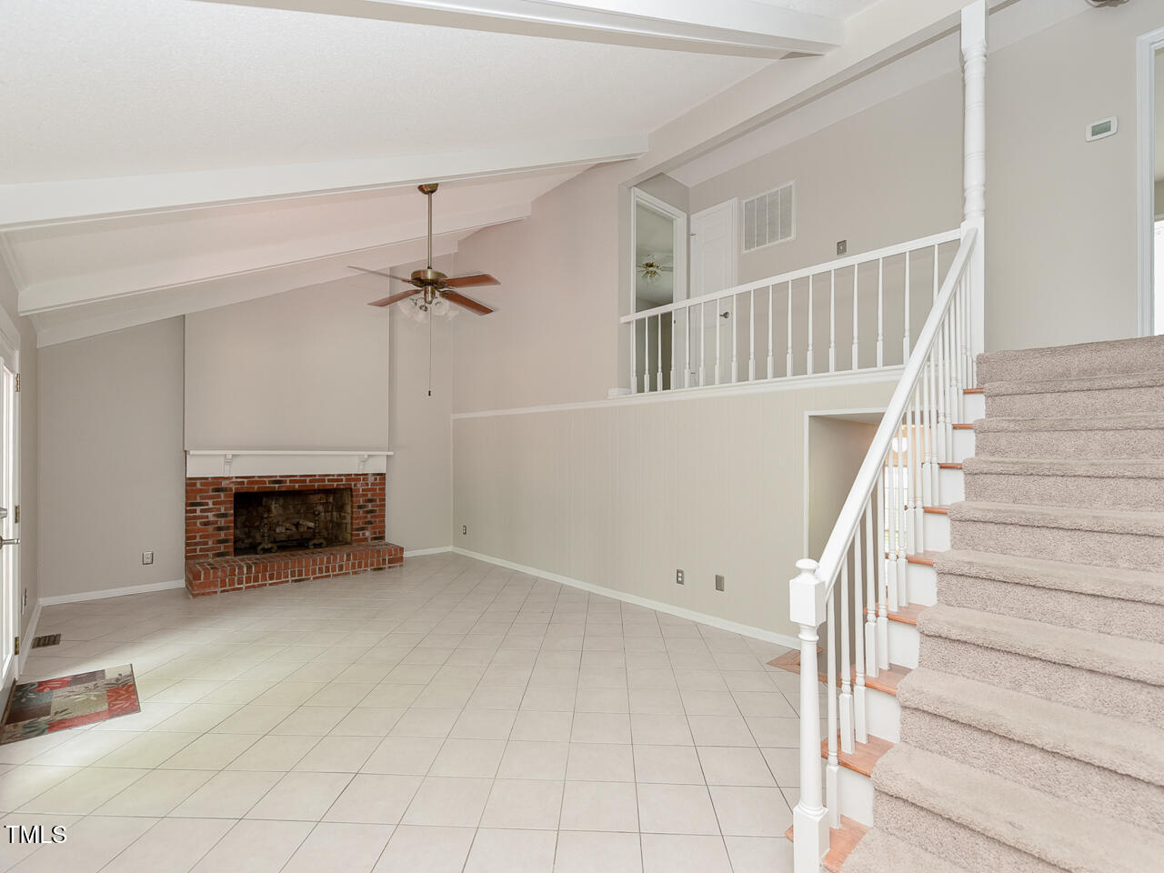 1215 Brookgreen Drive Cary, NC 27511 - Photo 30 of 40 a view of an empty room with fireplace and stairs