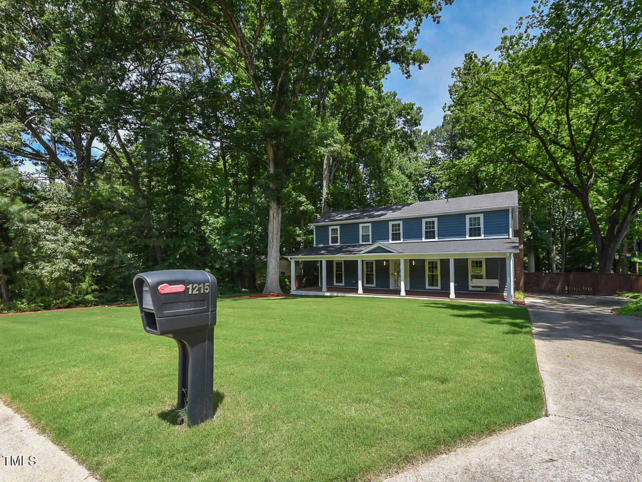 1215 Brookgreen Drive Cary, NC 27511 - Photo 7 of 40 a front view of a house with a garden and trees