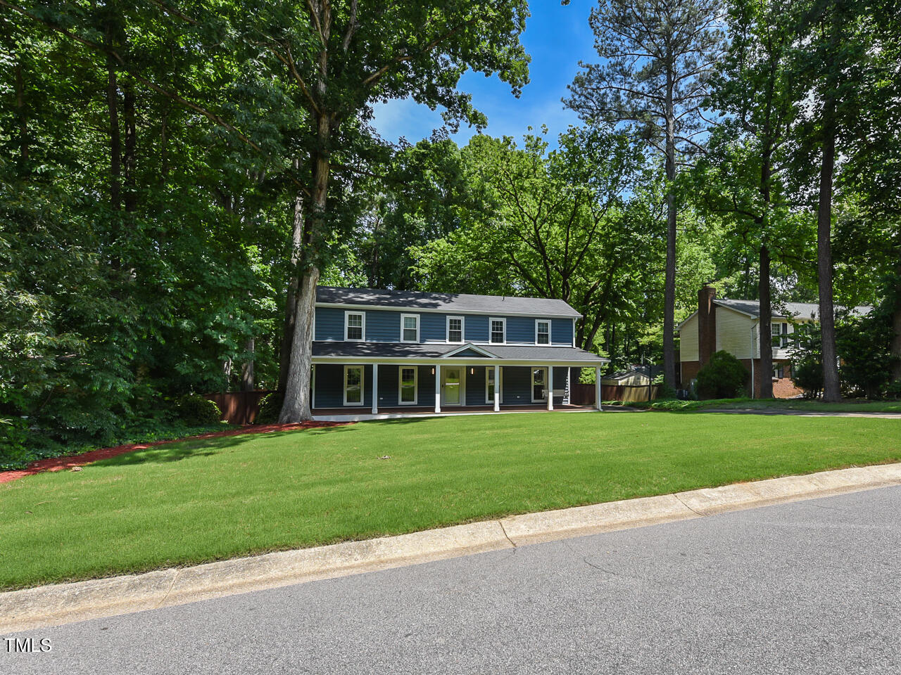 1215 Brookgreen Drive Cary, NC 27511 - Photo 8 of 40 a front view of a house with a yard table and chairs