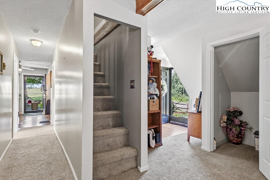 370 Osee Road Sparta, NC 28675 - Photo 20 of 36 a view of a hallway to a livingroom and a livingroom with furniture