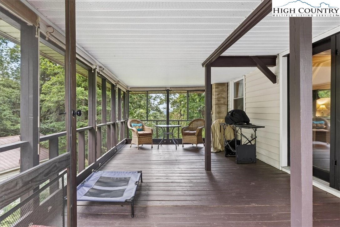 370 Osee Road Sparta, NC 28675 - Photo 4 of 36 a balcony with chairs and wooden floor