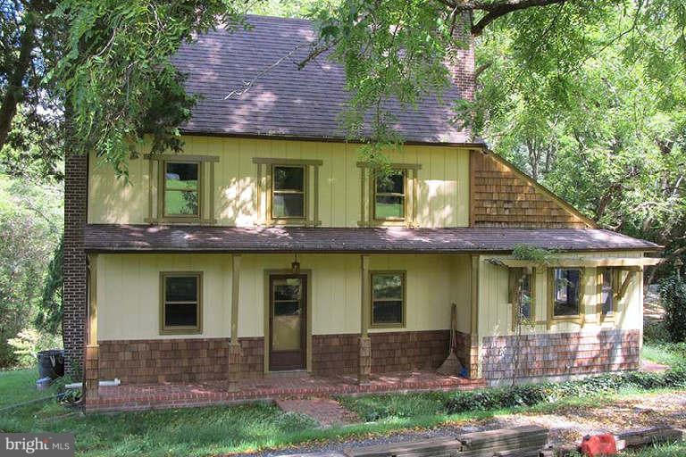 a view of a brick house with a large windows and a yard
