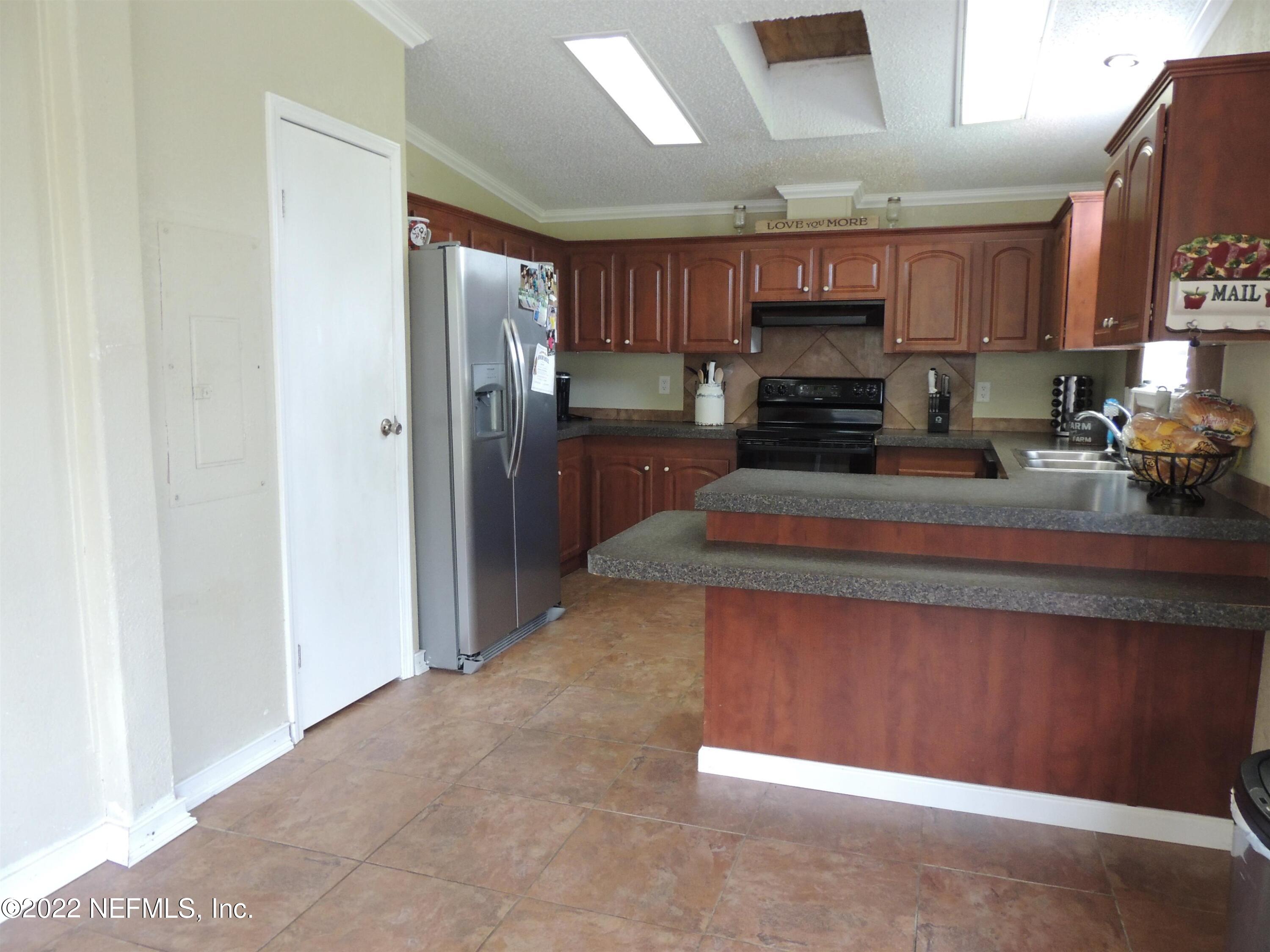 1801 Forbes Road St. Augustine, FL 32092 - Photo 4 of 28 a kitchen with stainless steel appliances granite countertop a refrigerator a sink and a stove