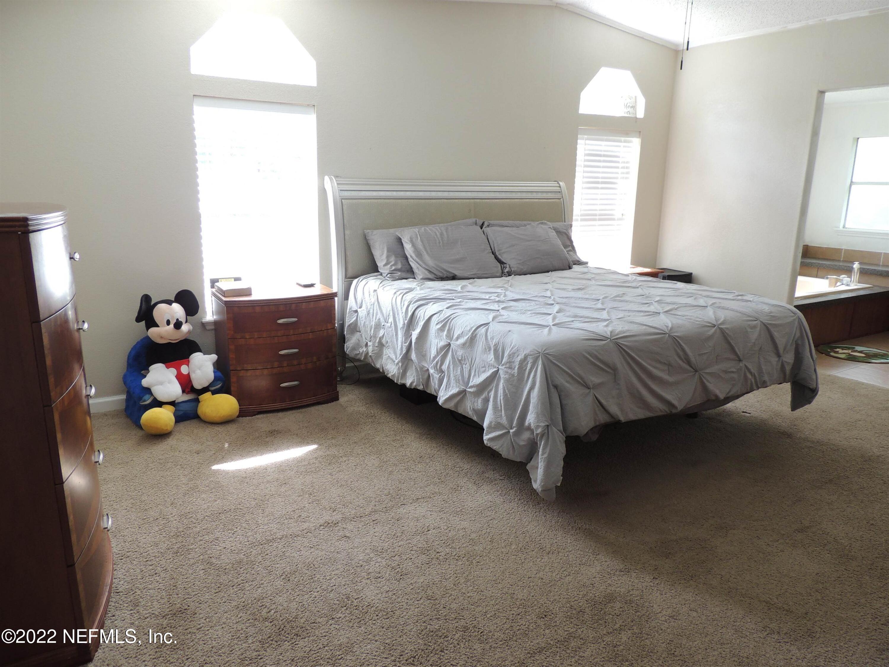 1801 Forbes Road St. Augustine, FL 32092 - Photo 9 of 28 a bed sitting in a bedroom next to a window