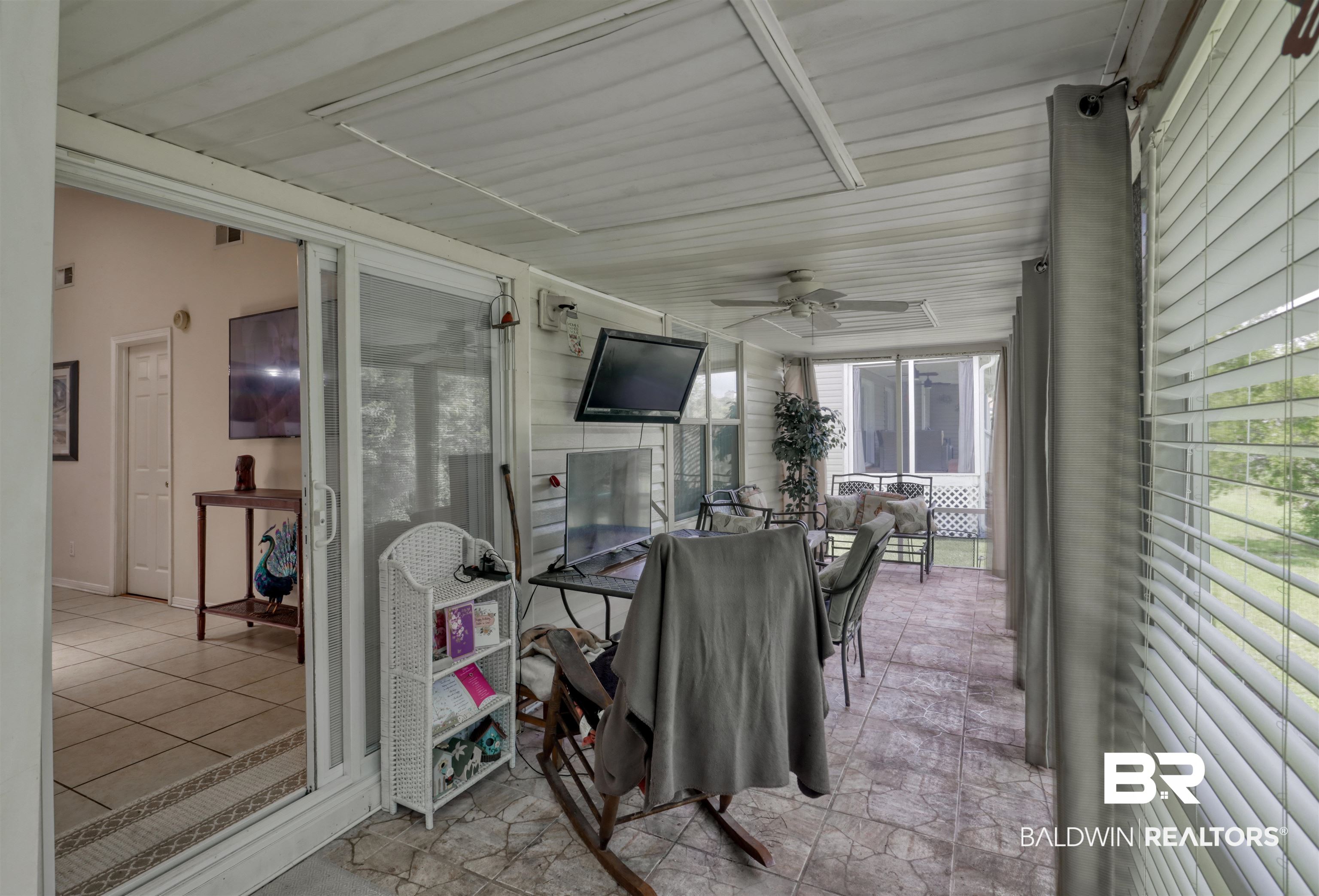 3200 Loop Road, Unit 61 Orange Beach, AL 36561 - Photo 19 of 32 Sunroom with ceiling fan, outdoor dining area, and plenty of natural light
