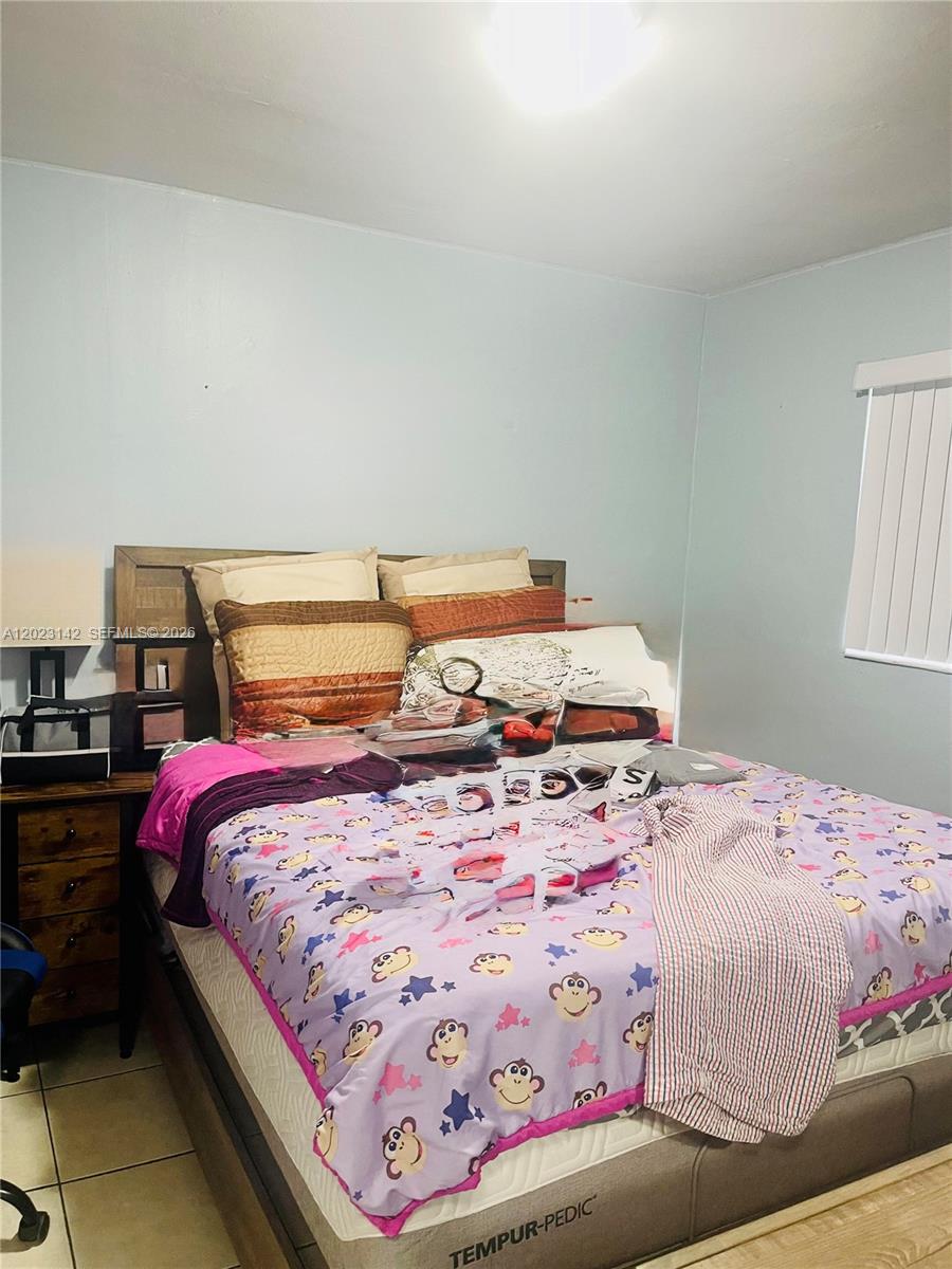 3410 Southwest 89th Court Miami, FL 33165 - Photo 11 of 18 a bedroom with a bed and window