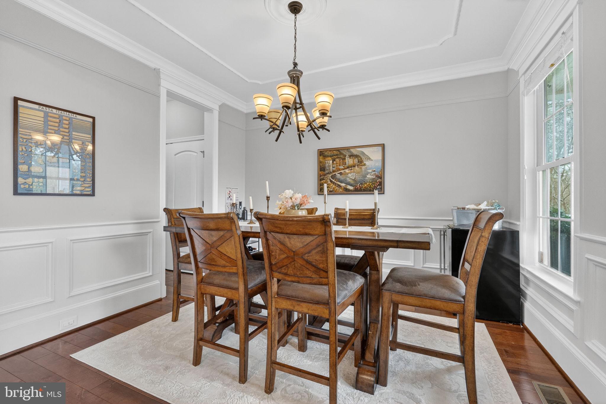 3112 Spring Drive Alexandria, VA 22306 - Photo 11 of 58 a view of a dining room with furniture a chandelier and wooden floor