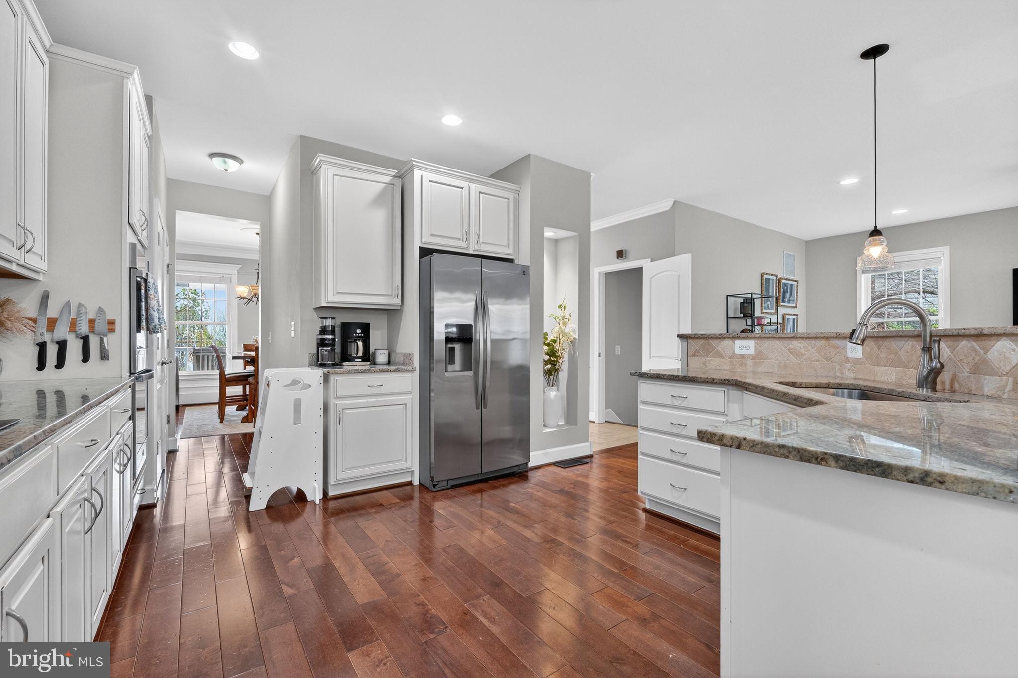 3112 Spring Drive Alexandria, VA 22306 - Photo 20 of 58 a kitchen with stainless steel appliances granite countertop a refrigerator a sink a stove and a wooden floors