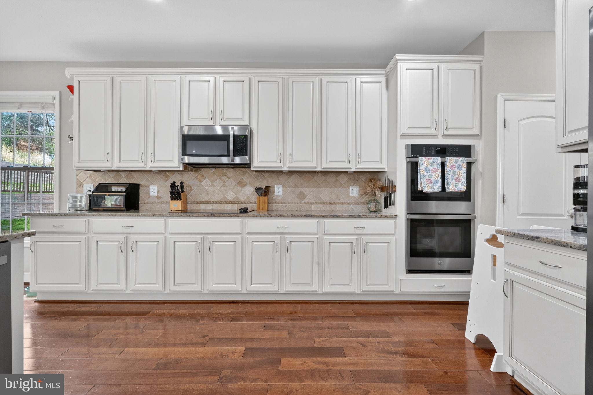 3112 Spring Drive Alexandria, VA 22306 - Photo 21 of 58 a kitchen with granite countertop white cabinets and stainless steel appliances