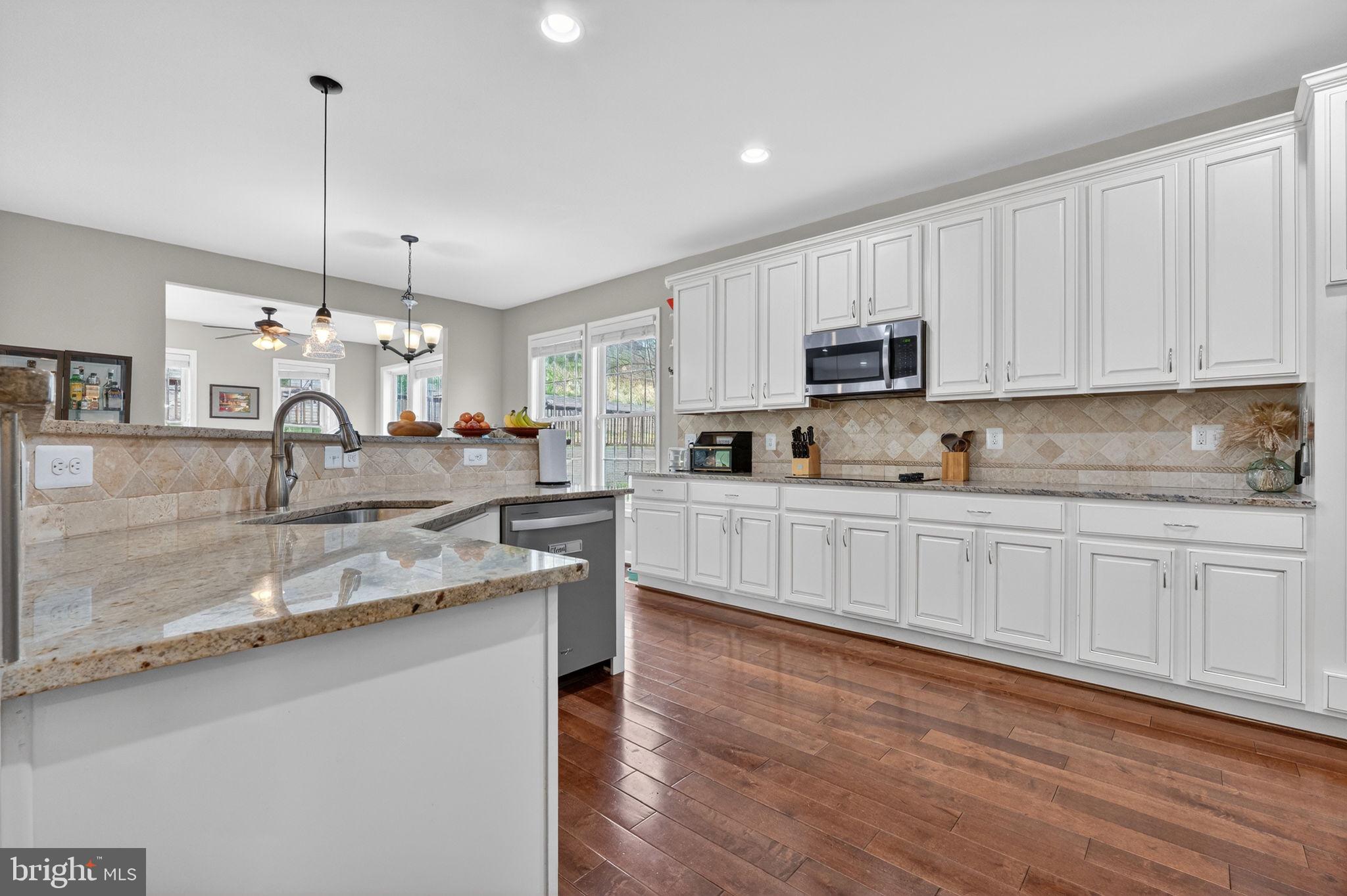 3112 Spring Drive Alexandria, VA 22306 - Photo 22 of 58 a kitchen with granite countertop a sink cabinets and wooden floor