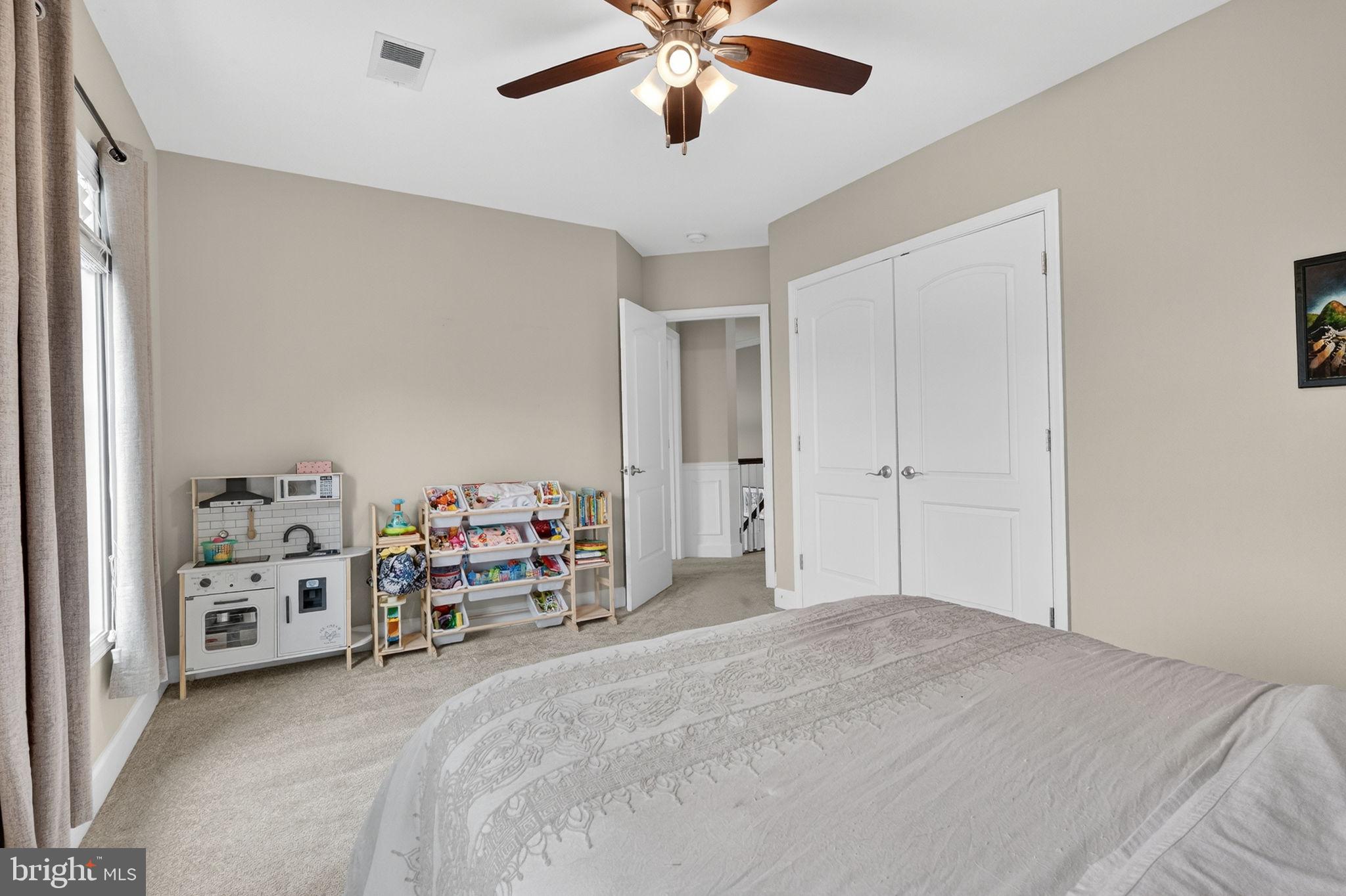 3112 Spring Drive Alexandria, VA 22306 - Photo 30 of 58 a bedroom with bed and a chandelier