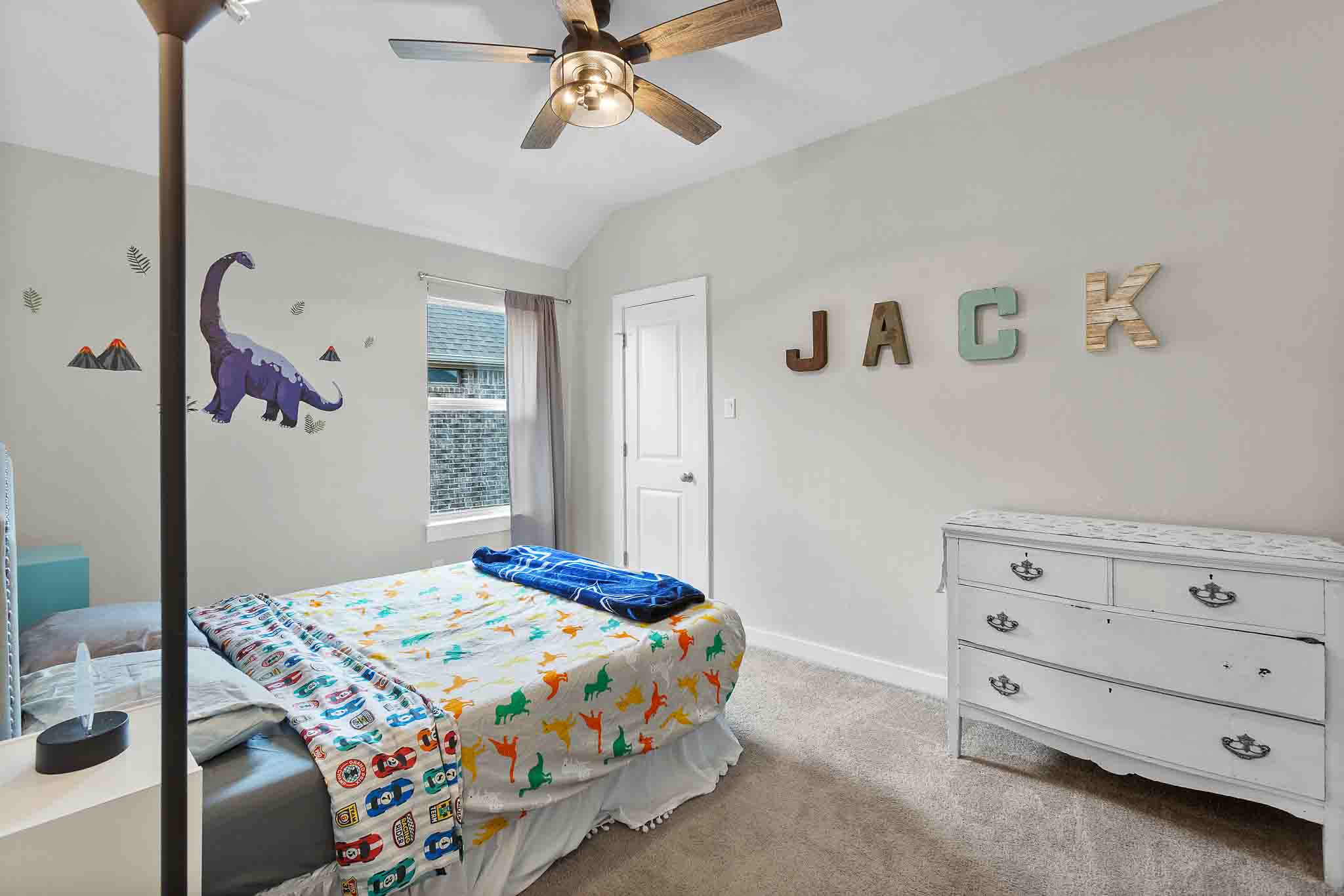 7717 Pace Ravine Drive Lago Vista, TX 78645 - Photo 24 of 39 a bedroom that has a bed and a chandelier