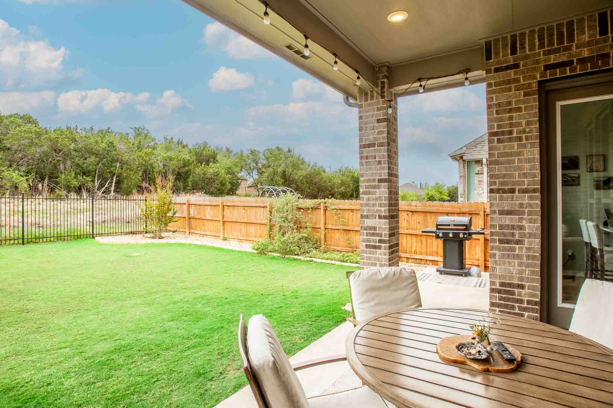 7717 Pace Ravine Drive Lago Vista, TX 78645 - Photo 28 of 39 a view of a patio with a table chairs and garden