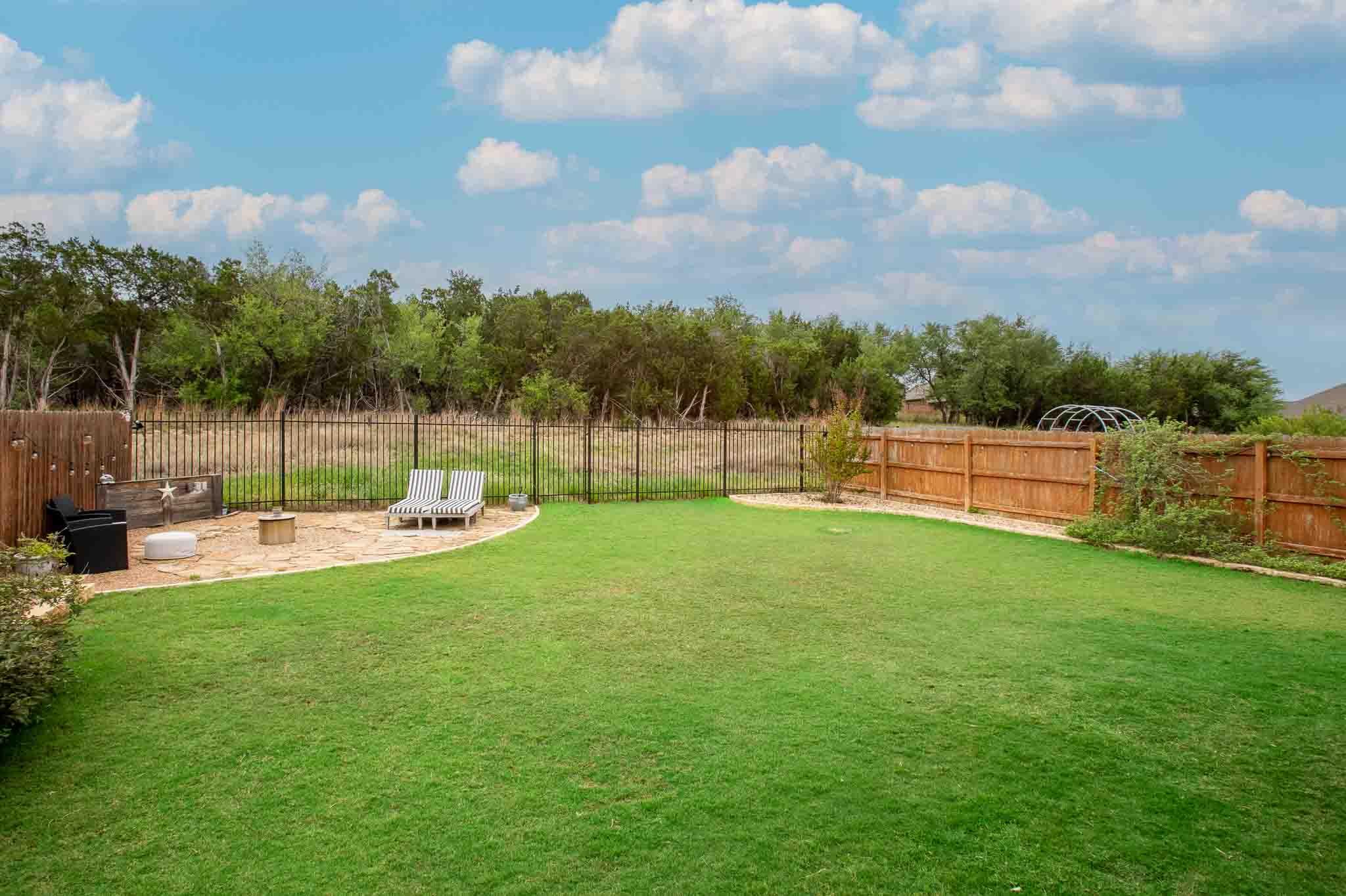 7717 Pace Ravine Drive Lago Vista, TX 78645 - Photo 31 of 39 a view of a garden with a swimming pool
