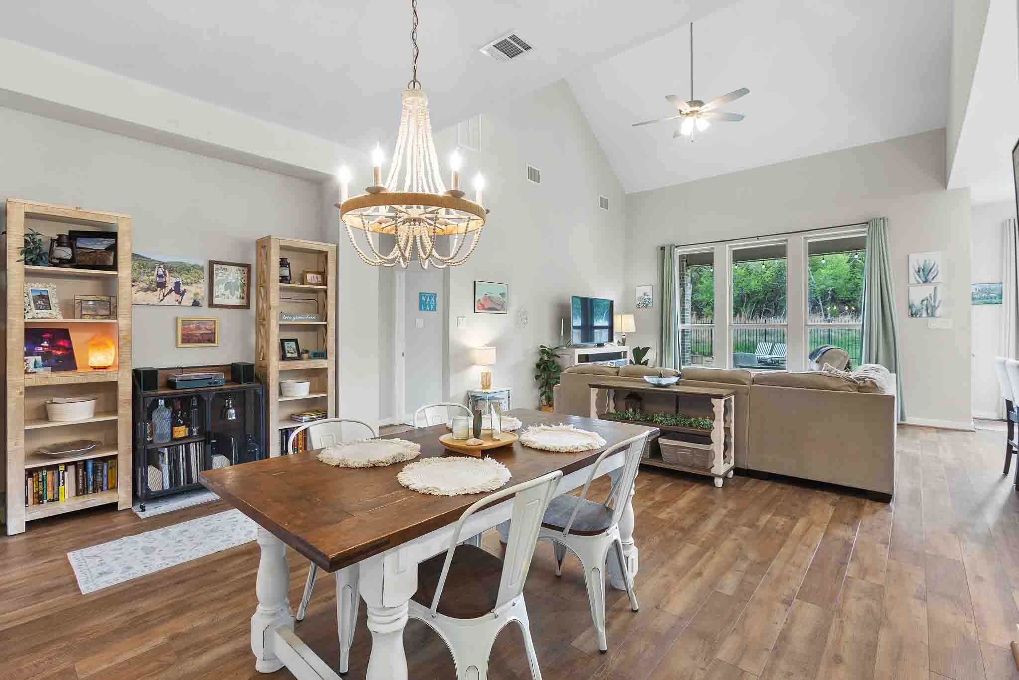7717 Pace Ravine Drive Lago Vista, TX 78645 - Photo 5 of 39 a view of a dining room with furniture window and wooden floor