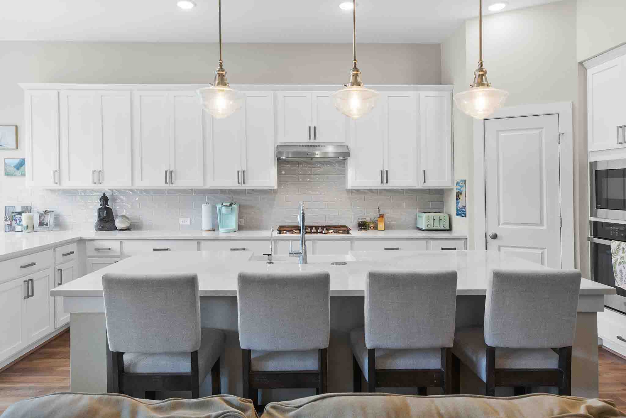 7717 Pace Ravine Drive Lago Vista, TX 78645 - Photo 9 of 39 a kitchen with stainless steel appliances granite countertop a table chairs stove and white cabinets
