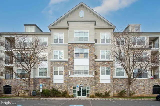 a front view of a residential apartment building with a yard