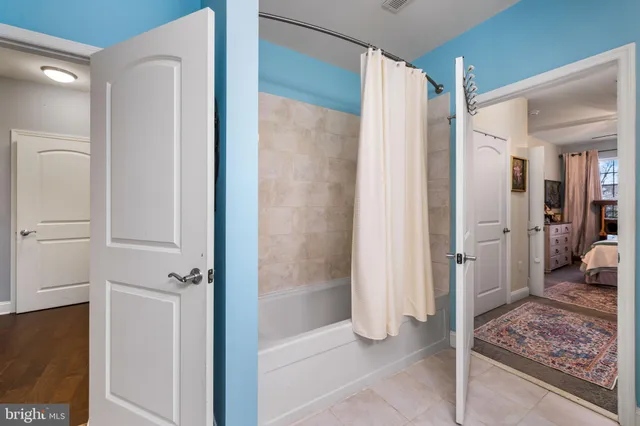 a bathroom with a shower and a glass door