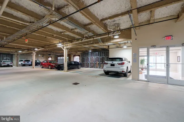 a view of parking area with parked cars
