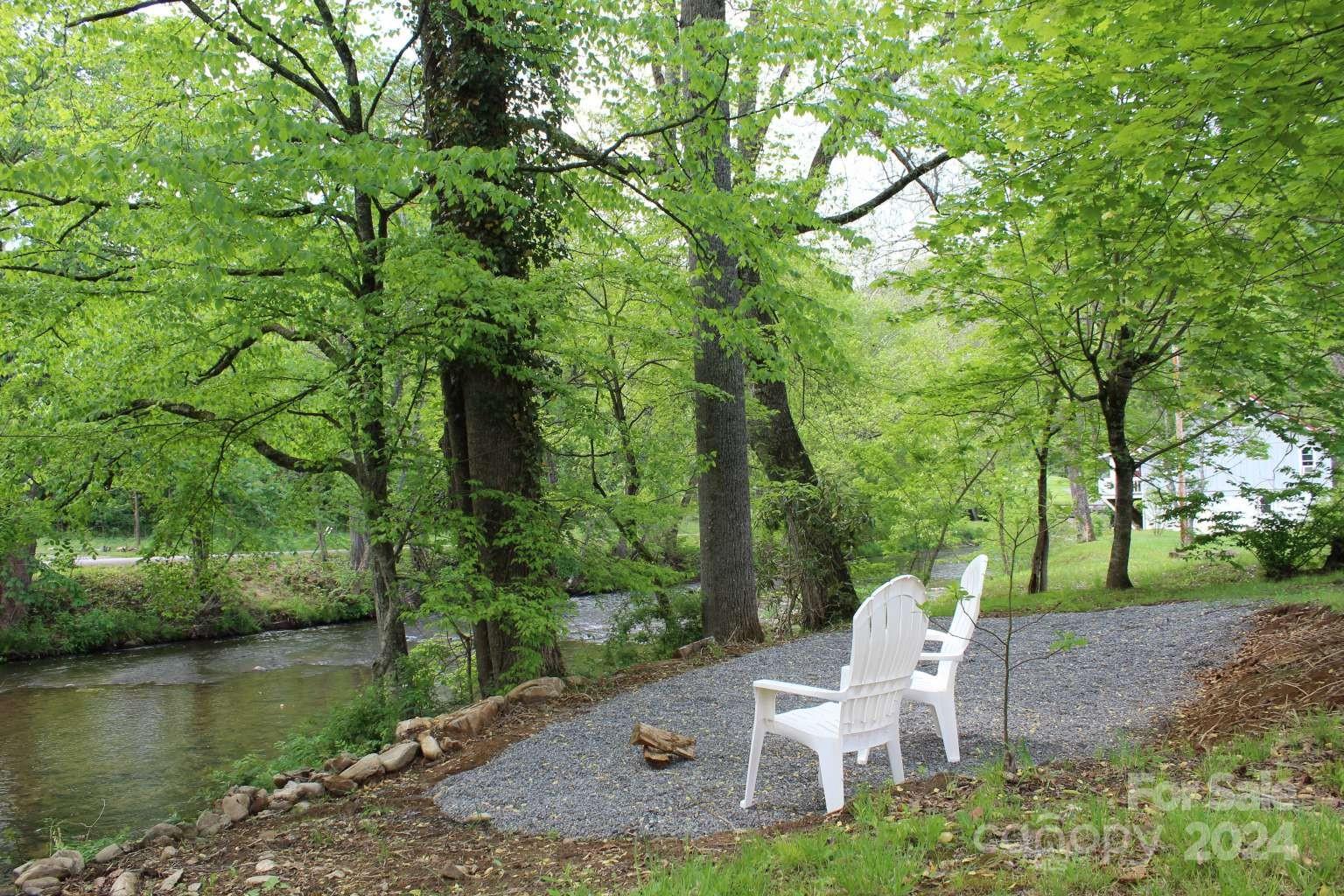 505 Mundy Field Road Canton, NC 28716 - Photo 15 of 22 a white bench sitting in a yard next to a yard