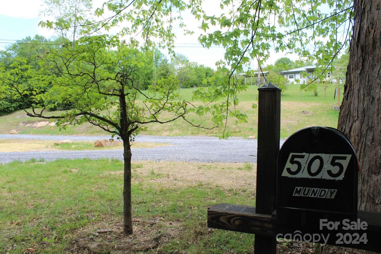 505 Mundy Field Road Canton, NC 28716 - Photo 21 of 22 a view of a street sign under a large tree