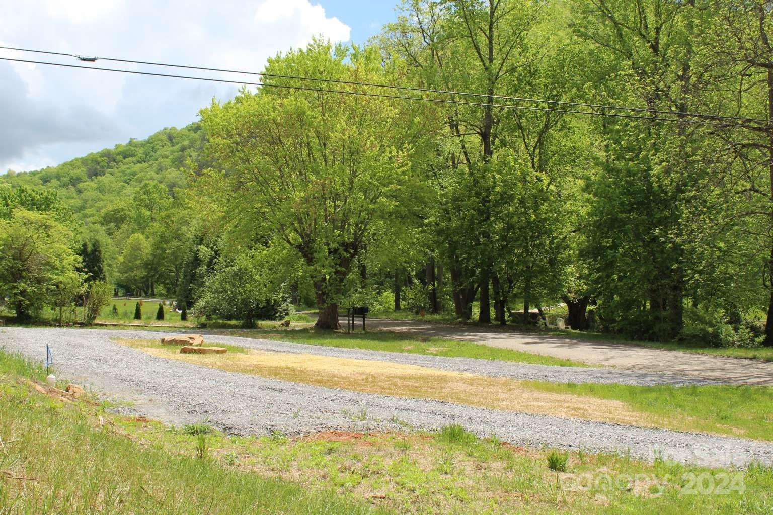505 Mundy Field Road Canton, NC 28716 - Photo 4 of 22 a view of a swimming pool with a big yard and large trees