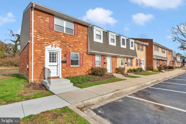 a front view of a brick house with a yard