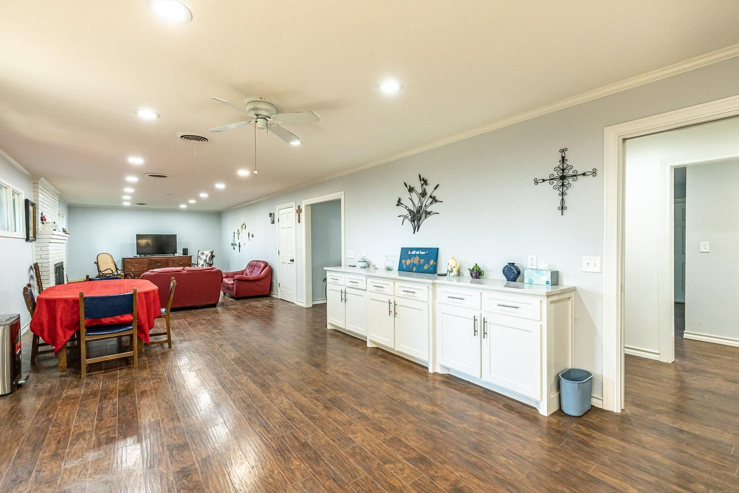 2327 60th Street Lubbock, TX 79412 - Photo 11 of 36 a living room with furniture and kitchen view with wooden floor