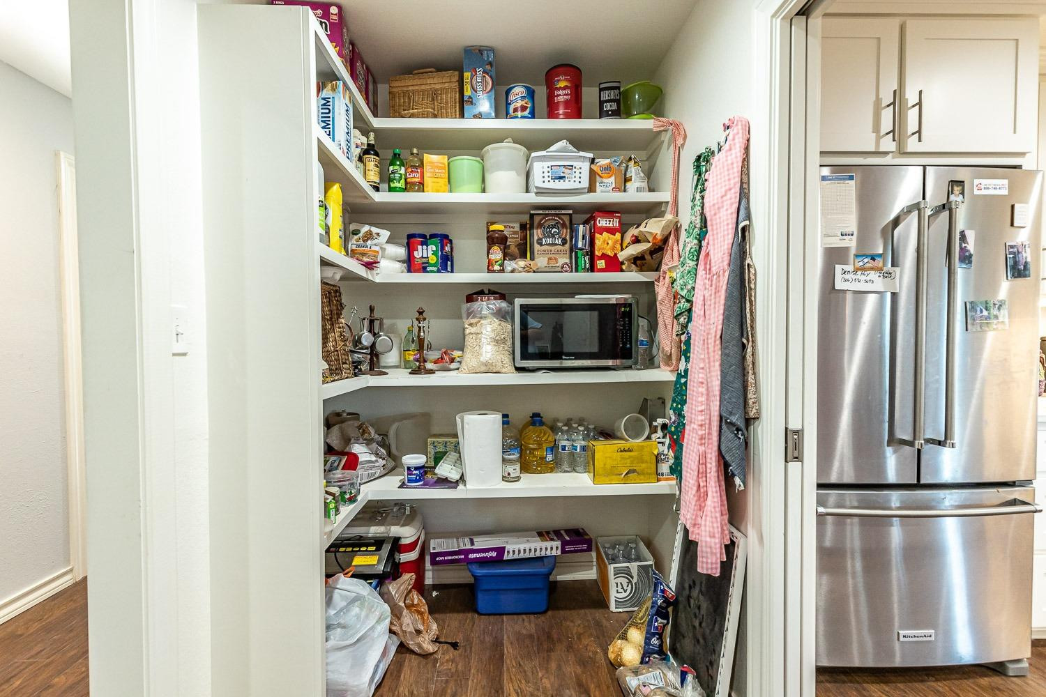 2327 60th Street Lubbock, TX 79412 - Photo 16 of 36 a room with a refrigerator and cabinets