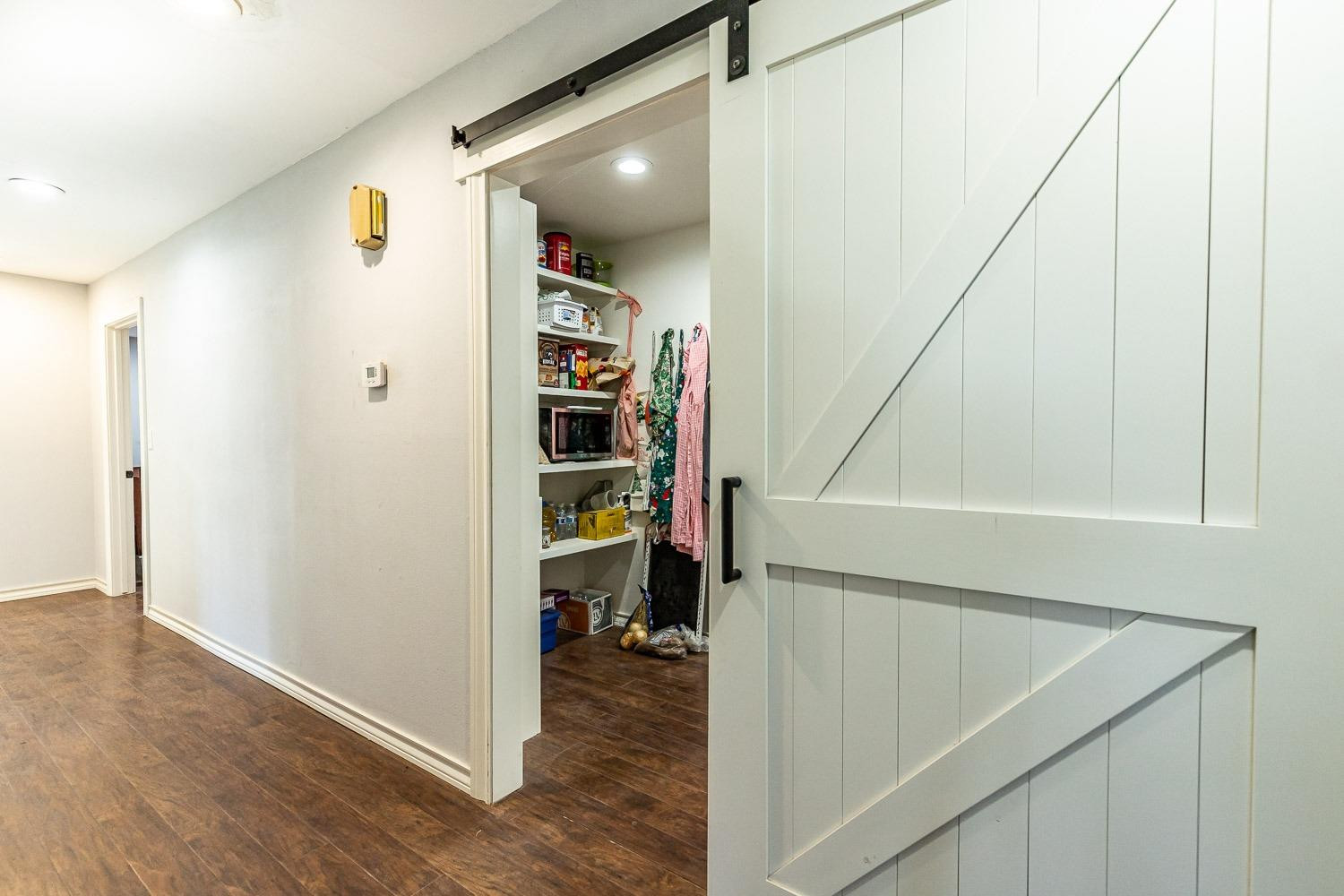 2327 60th Street Lubbock, TX 79412 - Photo 17 of 36 a view of walk in closet with clothes and shoes
