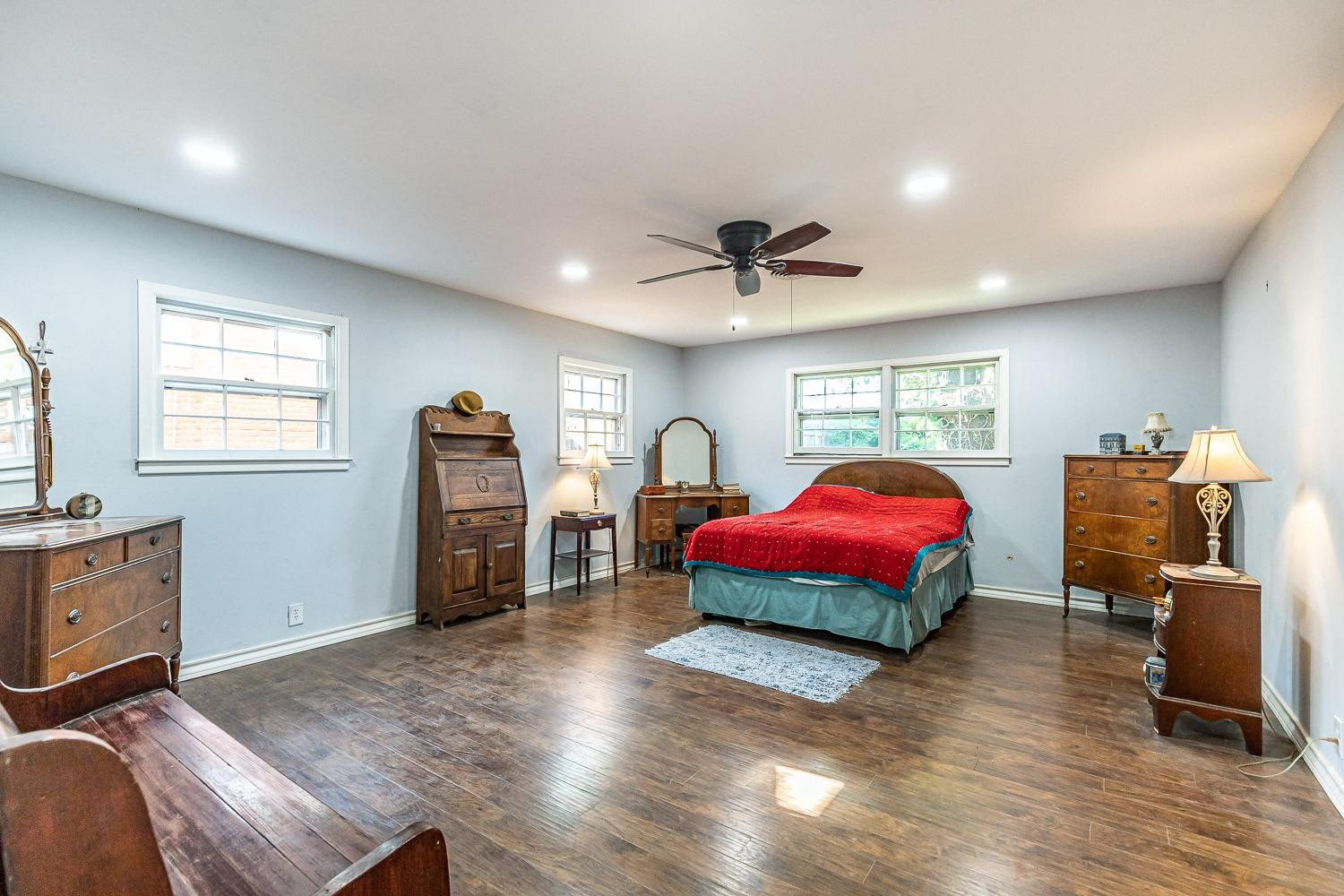 2327 60th Street Lubbock, TX 79412 - Photo 18 of 36 a bedroom with furniture and wooden floor