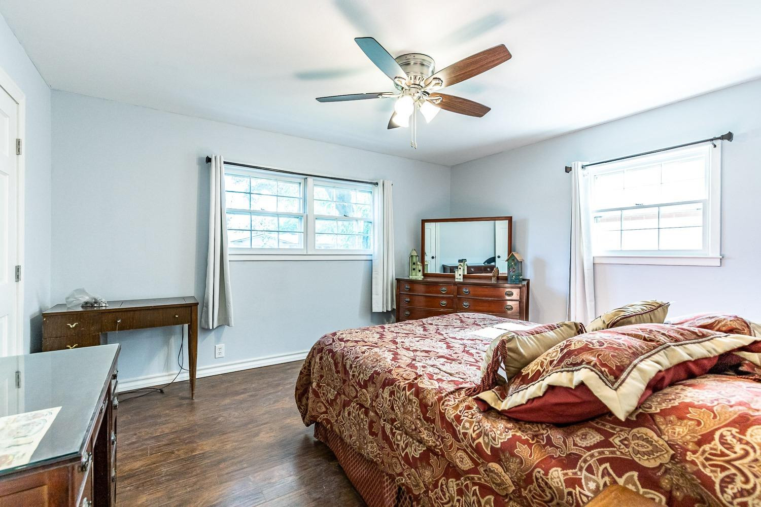 2327 60th Street Lubbock, TX 79412 - Photo 24 of 36 a bedroom with a bed and wooden floor