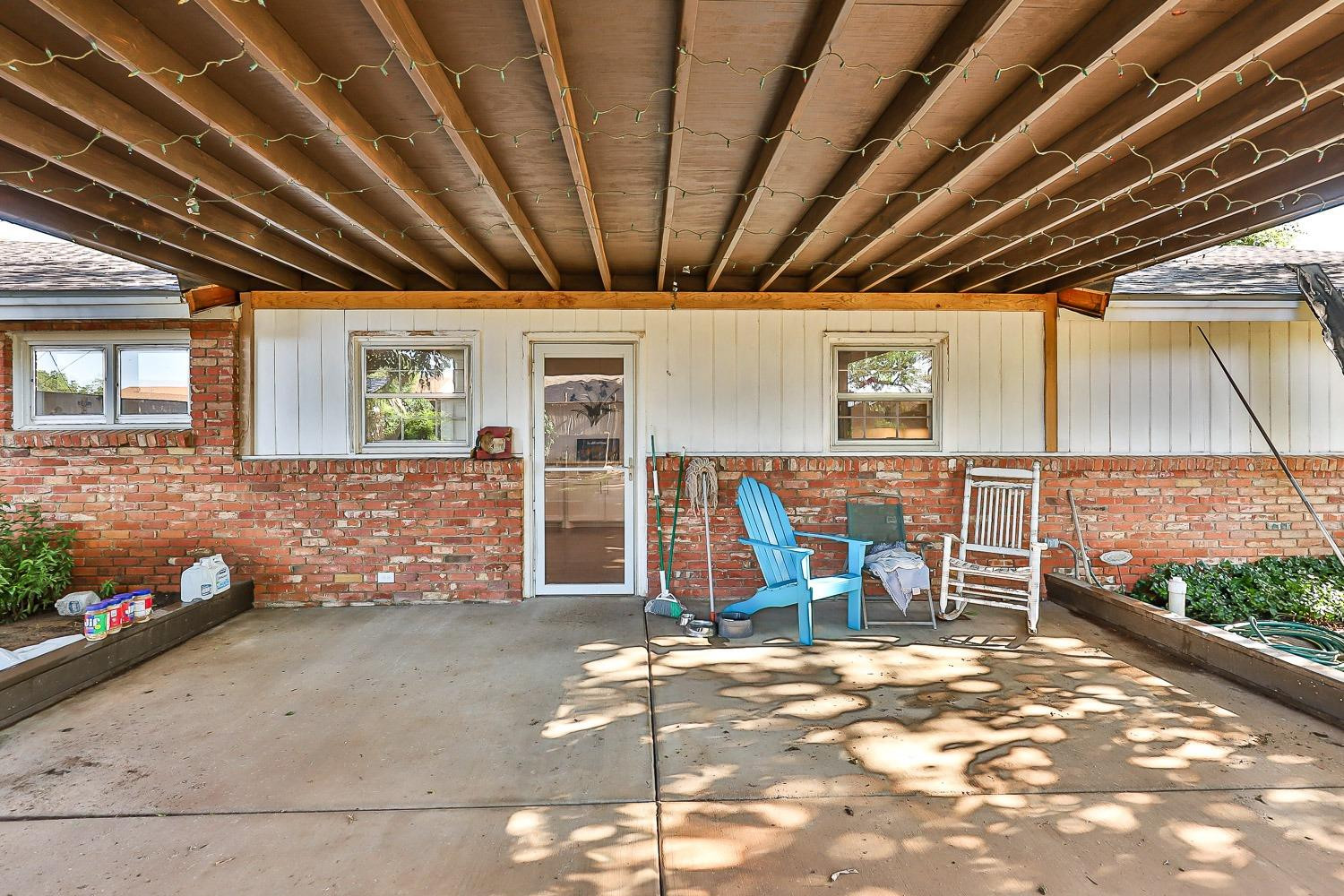 2327 60th Street Lubbock, TX 79412 - Photo 32 of 36 a view of a room with wooden floor and iron stairs