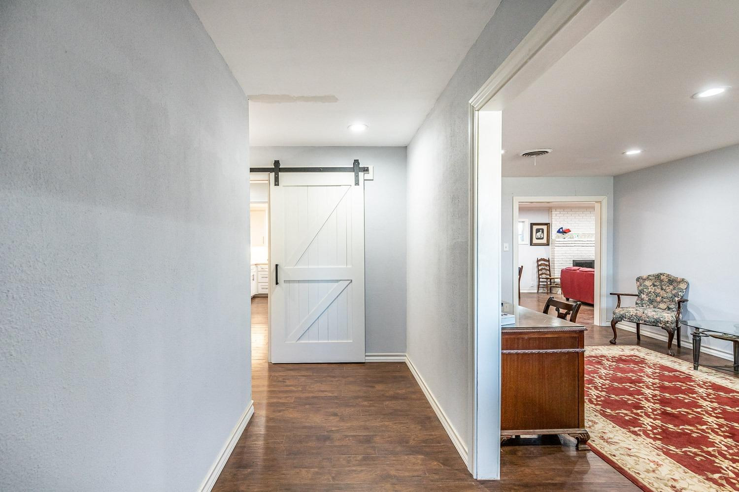 2327 60th Street Lubbock, TX 79412 - Photo 4 of 36 a view of a hallway and dining room with wooden floor