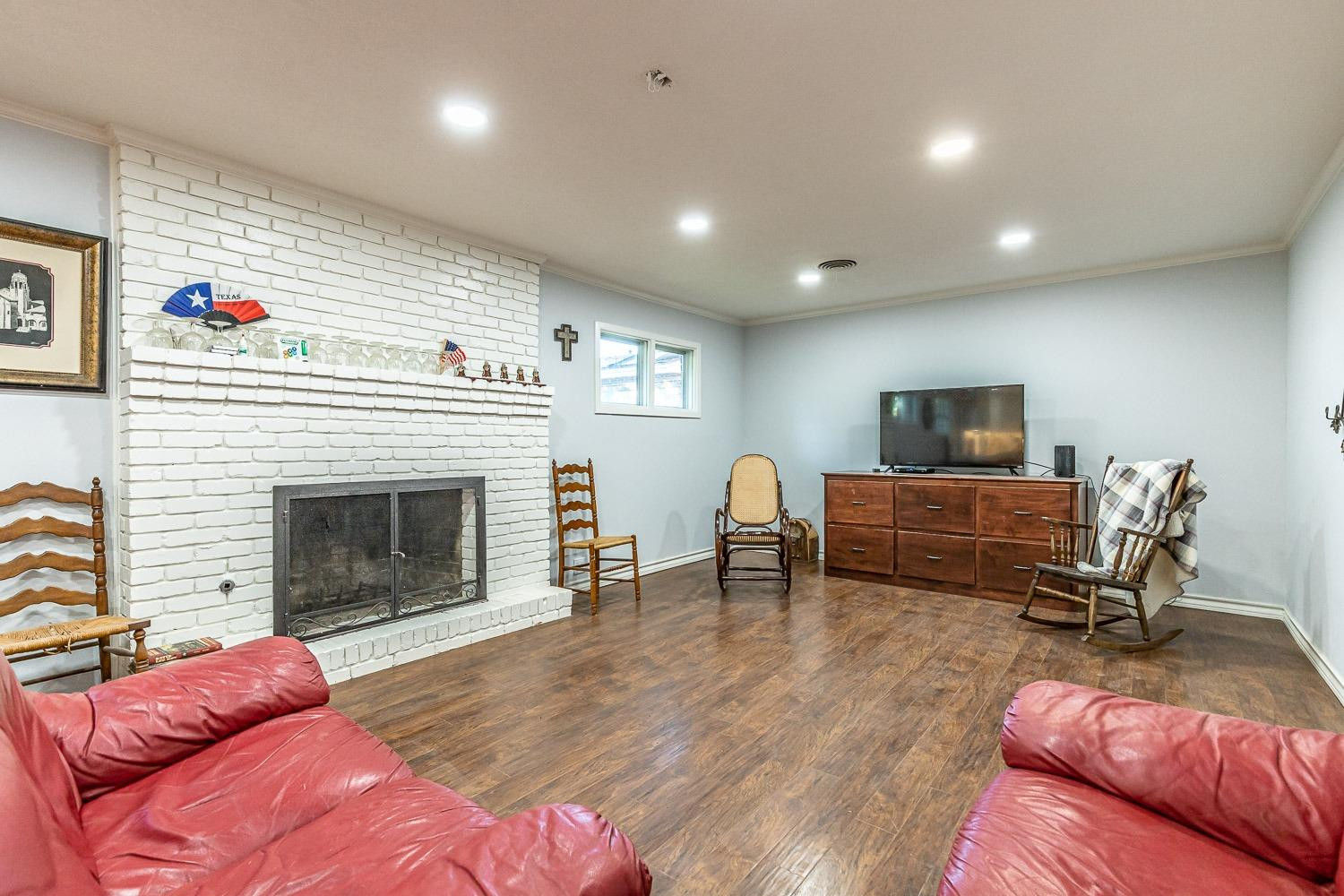 2327 60th Street Lubbock, TX 79412 - Photo 8 of 36 a living room with furniture and a fireplace