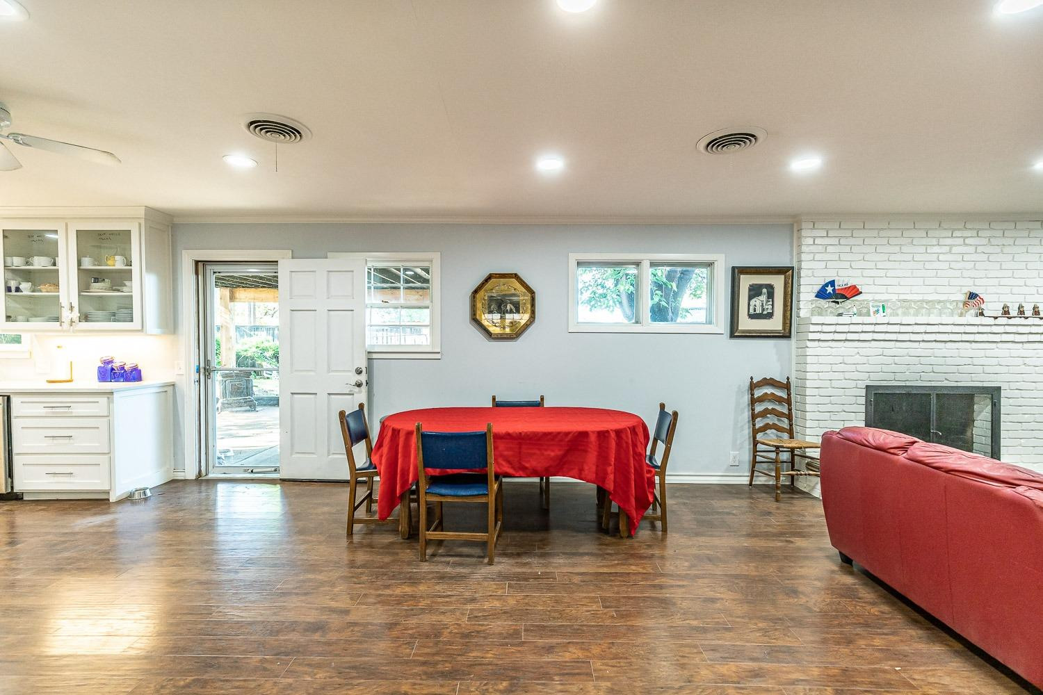 2327 60th Street Lubbock, TX 79412 - Photo 10 of 36 a living room with furniture a fireplace and wooden floor