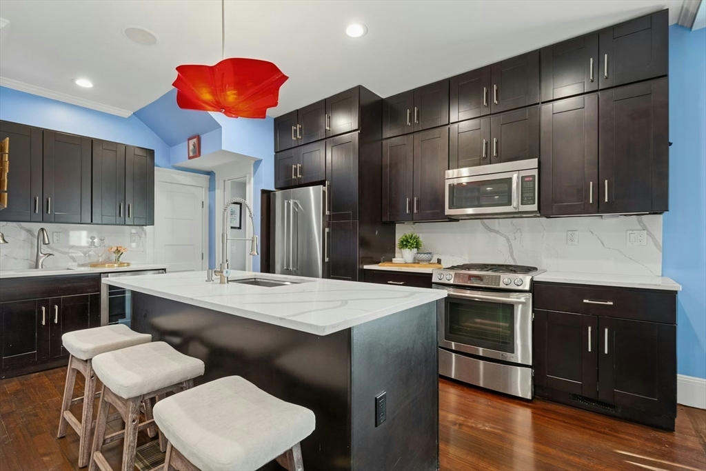 15 Oakview Terrace, Unit 2 Boston, MA 02130 - Photo 2 of 29 a kitchen with stainless steel appliances kitchen island granite countertop a sink stove and refrigerator