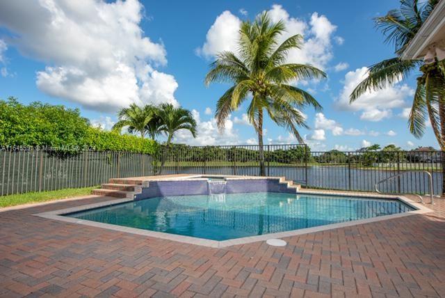 1737 Harbor View Circle Weston, FL 33327 - Photo 13 of 15 a view of a lake with a yard