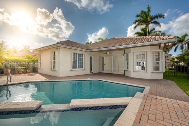 1737 Harbor View Circle Weston, FL 33327 - Photo 2 of 15 a front view of a house with garden
